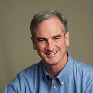 Picture of person in blue shirt smiling.